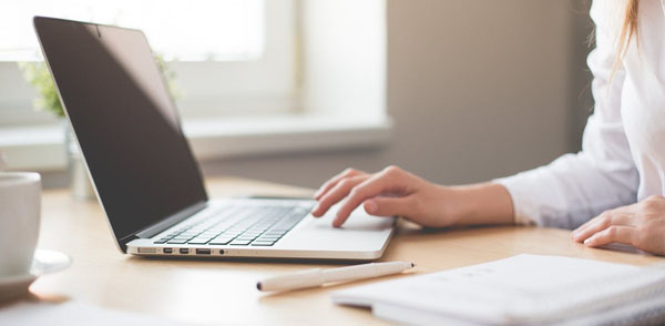 Person using a laptop on a table.